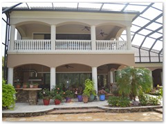 Two story balcony overlooking pool in a Stoughton & Duran custom home.